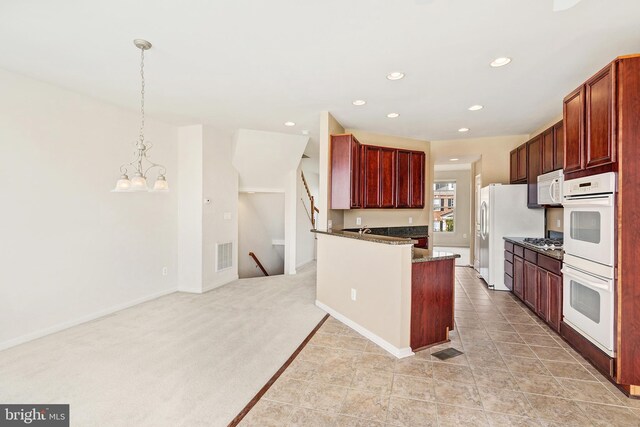 9207 Cascade Falls Dr, Bristow, VA 20136 - kitchen featuring white appliances, dark brown cabinets, a chandelier, recessed lighting, and hanging light fixtures