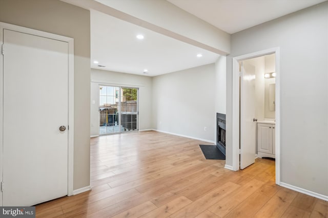 14629 Monmouth Dr Unit 10-112, Burtonsville, MD 20866 - spare room with a fireplace with flush hearth, light wood-style floors, recessed lighting, and baseboards