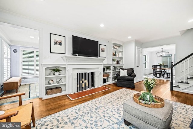 3311 Cameron Mills Rd, Alexandria, VA 22302 - living area featuring wood finished floors, stairs, built in features, ornamental molding, and a chandelier