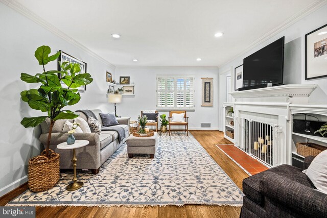 3311 Cameron Mills Rd, Alexandria, VA 22302 - living area featuring a fireplace with flush hearth, crown molding, wood finished floors, recessed lighting, and baseboards