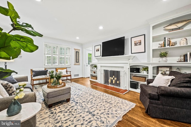 3311 Cameron Mills Rd, Alexandria, VA 22302 - living room featuring wood finished floors, recessed lighting, ornamental molding, and a fireplace