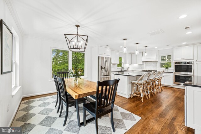 3311 Cameron Mills Rd, Alexandria, VA 22302 - dining room featuring a chandelier, recessed lighting, wood finished floors, baseboards, and ornamental molding