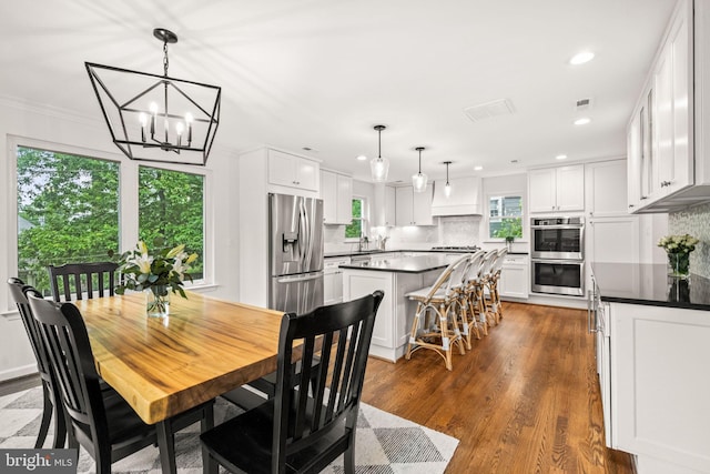 3311 Cameron Mills Rd, Alexandria, VA 22302 - dining room featuring recessed lighting, a chandelier, dark wood-type flooring, and ornamental molding