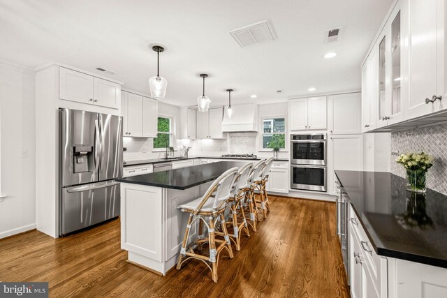 3311 Cameron Mills Rd, Alexandria, VA 22302 - kitchen featuring appliances with stainless steel finishes, dark countertops, a sink, white cabinets, and recessed lighting