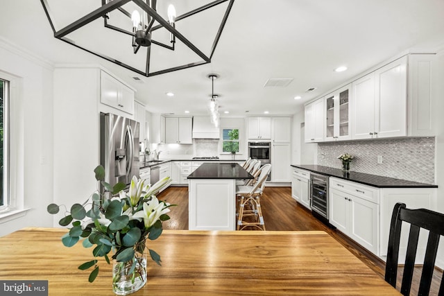 3311 Cameron Mills Rd, Alexandria, VA 22302 - kitchen featuring appliances with stainless steel finishes, wine cooler, dark countertops, white cabinetry, and recessed lighting