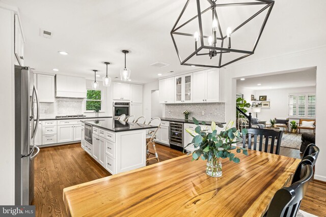 3311 Cameron Mills Rd, Alexandria, VA 22302 - dining space featuring beverage cooler, dark wood-style floors, recessed lighting, a chandelier, and ornamental molding