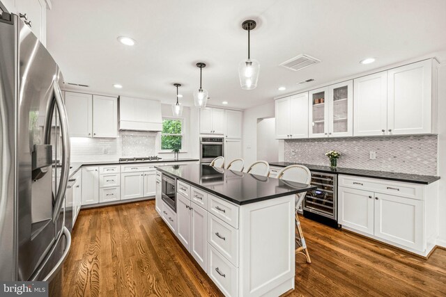 3311 Cameron Mills Rd, Alexandria, VA 22302 - kitchen with stainless steel appliances, wine cooler, dark countertops, dark wood finished floors, and recessed lighting