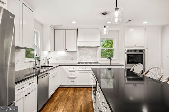3311 Cameron Mills Rd, Alexandria, VA 22302 - kitchen featuring a sink, appliances with stainless steel finishes, dark countertops, recessed lighting, and dark wood-type flooring