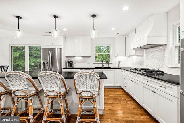 3311 Cameron Mills Rd, Alexandria, VA 22302 - kitchen featuring stainless steel appliances, premium range hood, a sink, dark countertops, and backsplash