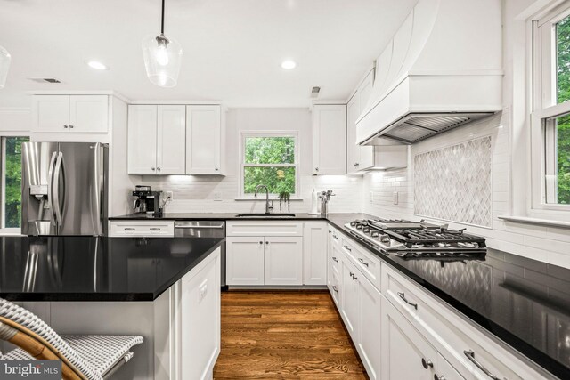3311 Cameron Mills Rd, Alexandria, VA 22302 - kitchen with stainless steel appliances, custom exhaust hood, a sink, dark countertops, and white cabinetry