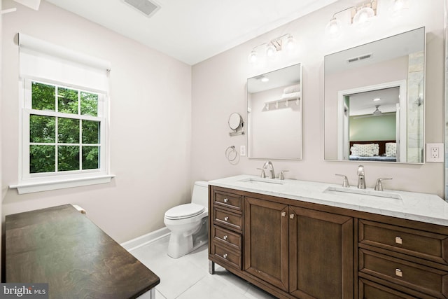 3311 Cameron Mills Rd, Alexandria, VA 22302 - bathroom with double vanity, toilet, tile patterned flooring, connected bathroom, and baseboards