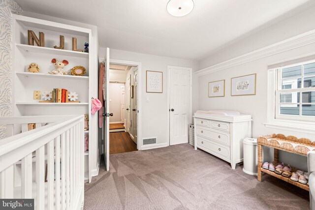 3311 Cameron Mills Rd, Alexandria, VA 22302 - carpeted bedroom featuring a nursery area and baseboards