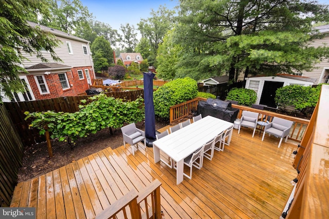 3311 Cameron Mills Rd, Alexandria, VA 22302 - wooden deck with outdoor dining space and a fenced backyard