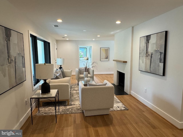 1324 Kingston Ave, Alexandria, VA 22302 - living area with baseboards, wood finished floors, a fireplace with flush hearth, and recessed lighting