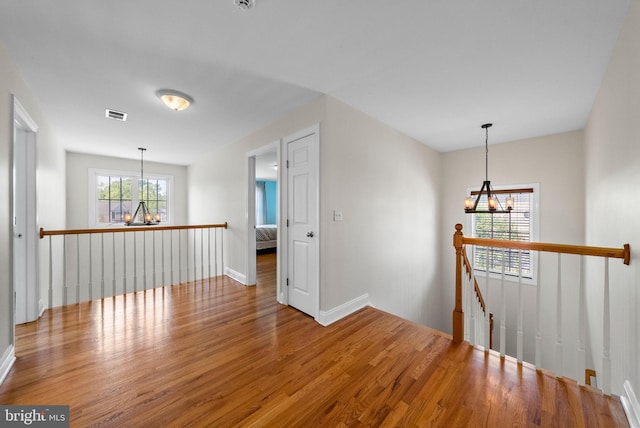 143 Oak St, Bridgewater, NJ 08807 - empty room featuring a chandelier, wood finished floors, and baseboards
