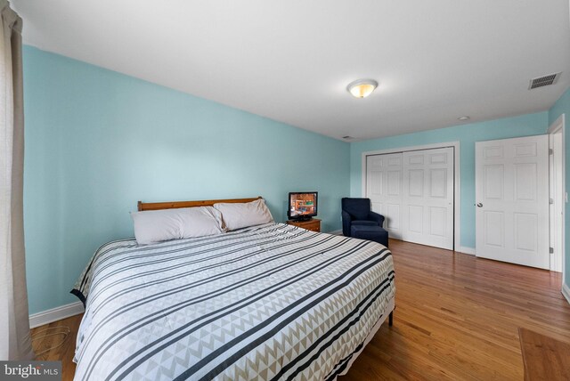 143 Oak St, Bridgewater, NJ 08807 - bedroom featuring a closet, baseboards, and wood finished floors