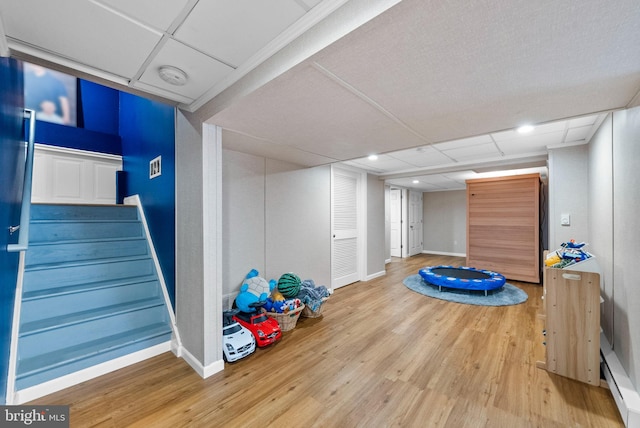 143 Oak St, Bridgewater, NJ 08807 - rec room with baseboard heating, wood finished floors, baseboards, and recessed lighting