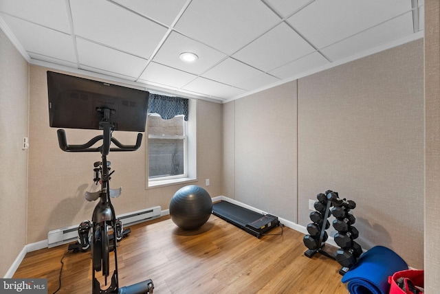 143 Oak St, Bridgewater, NJ 08807 - exercise area with wood finished floors, baseboard heating, baseboards, a paneled ceiling, and crown molding
