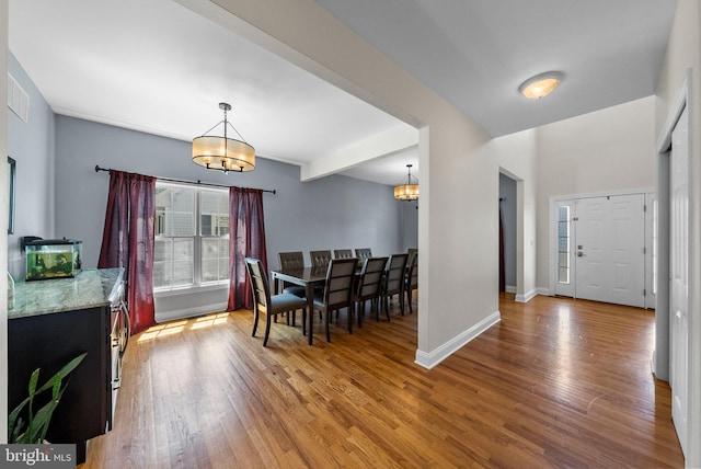 143 Oak St, Bridgewater, NJ 08807 - dining space with a chandelier, wood finished floors, and baseboards