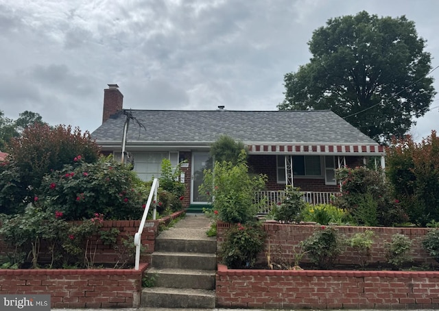 8031 New Riggs Rd, Hyattsville, MD 20783 - view of front of home featuring a porch, a chimney, brick siding, and roof with shingles