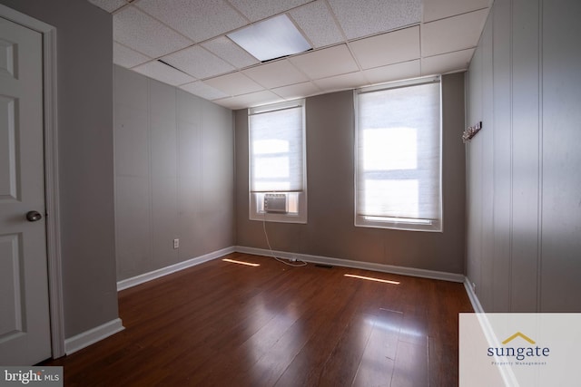 1210 Sargeant St, Baltimore, MD 21223 - empty room with dark wood-type flooring, a drop ceiling, and cooling unit