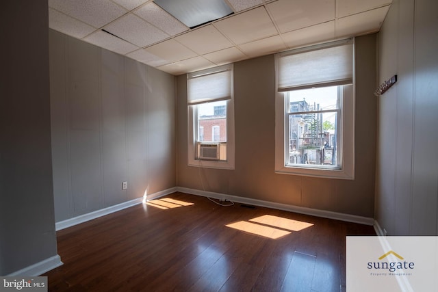 1210 Sargeant St, Baltimore, MD 21223 - spare room with wood finished floors, a drop ceiling, and cooling unit