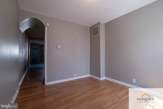 1210 Sargeant St, Baltimore, MD 21223 - spare room with light wood finished floors and arched walkways