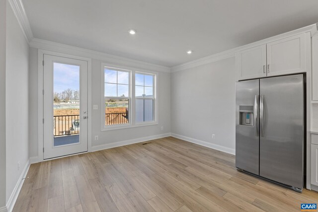 3615 Hilah Ln, Charlottesville, VA 22901 - kitchen with stainless steel fridge, ornamental molding, baseboards, light wood finished floors, and white cabinetry