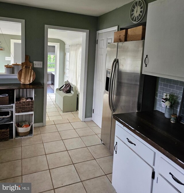 102 Northside Rd, Elverson, PA 19520 - kitchen featuring dark countertops, light tile patterned floors, stainless steel refrigerator with ice dispenser, and decorative backsplash