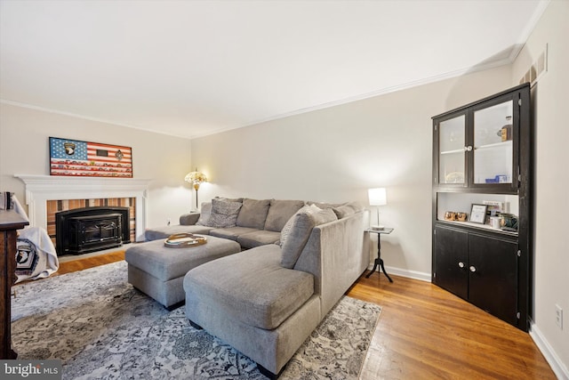 2722 E Riding Dr, Wilmington, DE 19808 - living room featuring light wood-type flooring, crown molding, baseboards, and a brick fireplace
