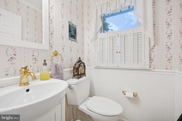 2722 E Riding Dr, Wilmington, DE 19808 - half bathroom featuring wallpapered walls, wainscoting, toilet, and vanity