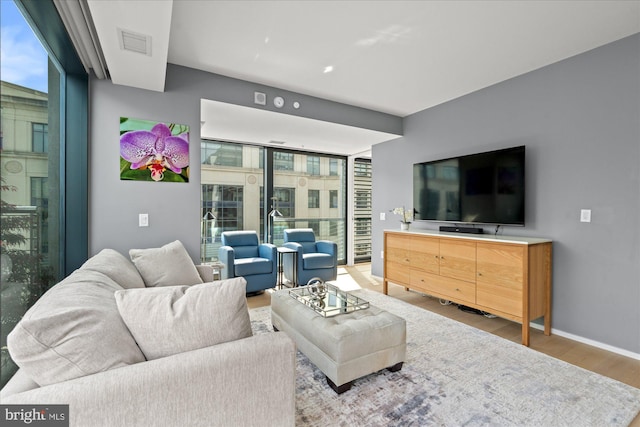 925 H St NW Unit 810, Washington, DC 20001 - living room with wood finished floors, plenty of natural light, and baseboards