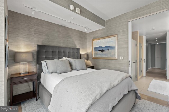 925 H St NW Unit 810, Washington, DC 20001 - bedroom featuring track lighting, wallpapered walls, and light tile patterned floors