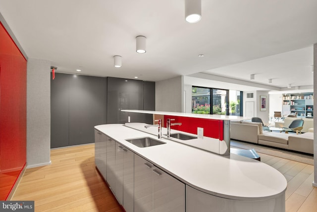 925 H St NW Unit 810, Washington, DC 20001 - kitchen featuring a sink, open floor plan, an island with sink, light wood finished floors, and recessed lighting