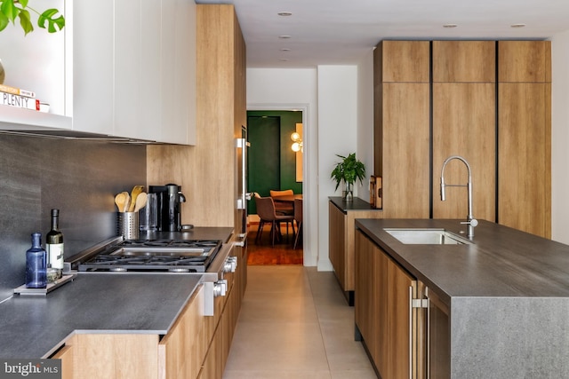1914 35th St NW, Washington, DC 20007 - kitchen featuring dark countertops, modern cabinets, beverage cooler, light tile patterned floors, and brown cabinets
