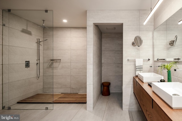 1914 35th St NW, Washington, DC 20007 - bathroom with tile walls, double vanity, walk in shower, tile patterned flooring, and recessed lighting