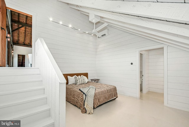 820 Spring Hill Rd, Riegelsville, PA 18077 - bedroom with wood walls, a wall mounted AC, and finished concrete flooring