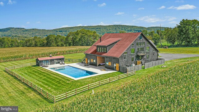 820 Spring Hill Rd, Riegelsville, PA 18077 - back of house with an outdoor pool, a patio area, an outdoor structure, and a forest view