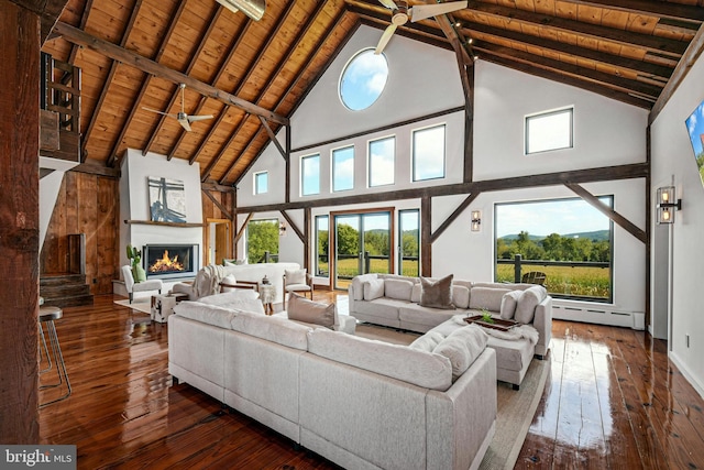820 Spring Hill Rd, Riegelsville, PA 18077 - living room featuring high vaulted ceiling, a baseboard radiator, a warm lit fireplace, wood-type flooring, and wooden ceiling with exposed beams