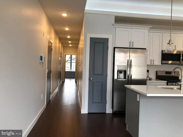 1337 N Franklin St, Philadelphia, PA 19122 - kitchen featuring appliances with stainless steel finishes, dark wood-style flooring, light countertops, recessed lighting, and baseboards