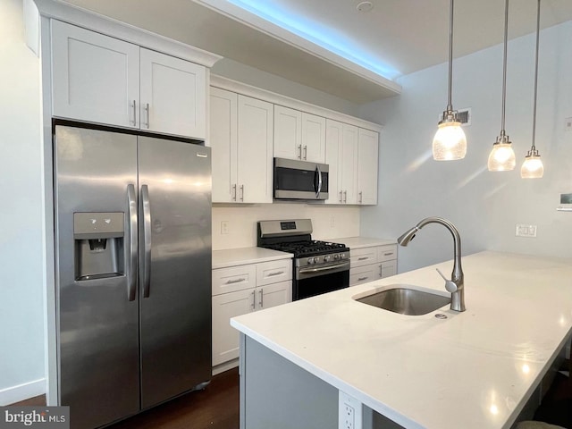 1337 N Franklin St, Philadelphia, PA 19122 - kitchen featuring stainless steel appliances, a sink, a peninsula, white cabinetry, and light countertops