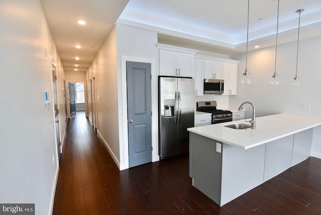 1337 N Franklin St, Philadelphia, PA 19122 - kitchen with stainless steel appliances, a sink, dark wood-style flooring, white cabinets, and hanging light fixtures