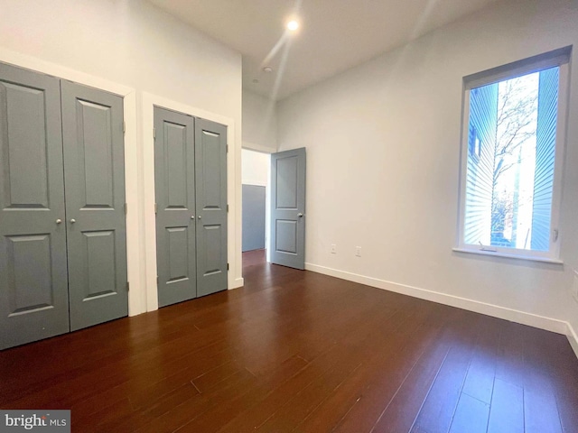 1337 N Franklin St, Philadelphia, PA 19122 - unfurnished bedroom featuring multiple closets, dark wood finished floors, and baseboards