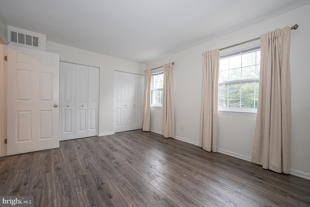 1380 Putnam Blvd Unit 4, Wallingford, PA 19086 - unfurnished bedroom featuring multiple closets, dark wood finished floors, and baseboards
