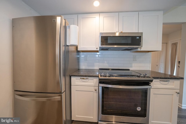 1380 Putnam Blvd Unit 4, Wallingford, PA 19086 - kitchen featuring appliances with stainless steel finishes, white cabinets, decorative backsplash, dark stone counters, and recessed lighting