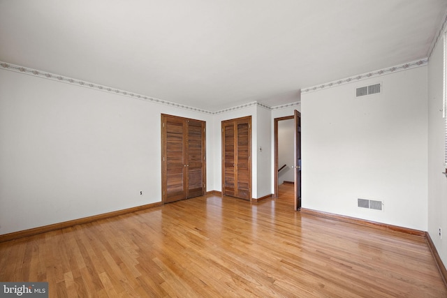 2507 Garth Rd, Wilmington, DE 19810 - unfurnished bedroom with light wood-style flooring, baseboards, and multiple closets