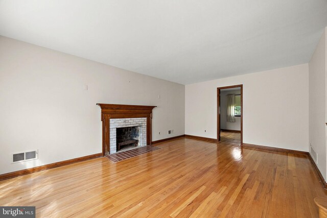 2507 Garth Rd, Wilmington, DE 19810 - unfurnished living room with light wood-type flooring, a fireplace, and baseboards