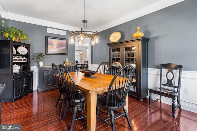 318 Windsor Rd, Mullica Hill, NJ 08062 - dining area with dark wood-type flooring, a wainscoted wall, and crown molding