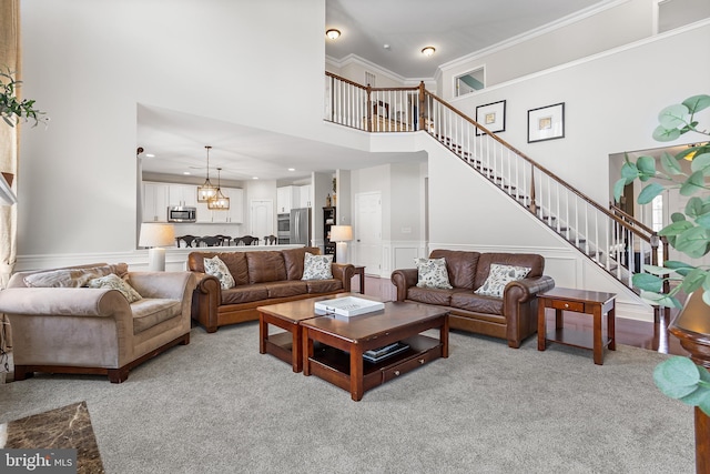 318 Windsor Rd, Mullica Hill, NJ 08062 - living area with a towering ceiling, stairs, light colored carpet, a decorative wall, and a chandelier