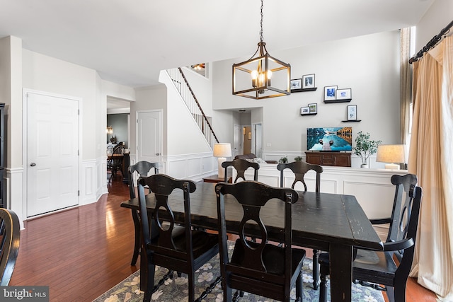 318 Windsor Rd, Mullica Hill, NJ 08062 - dining room with a chandelier, wood finished floors, a wainscoted wall, and stairway